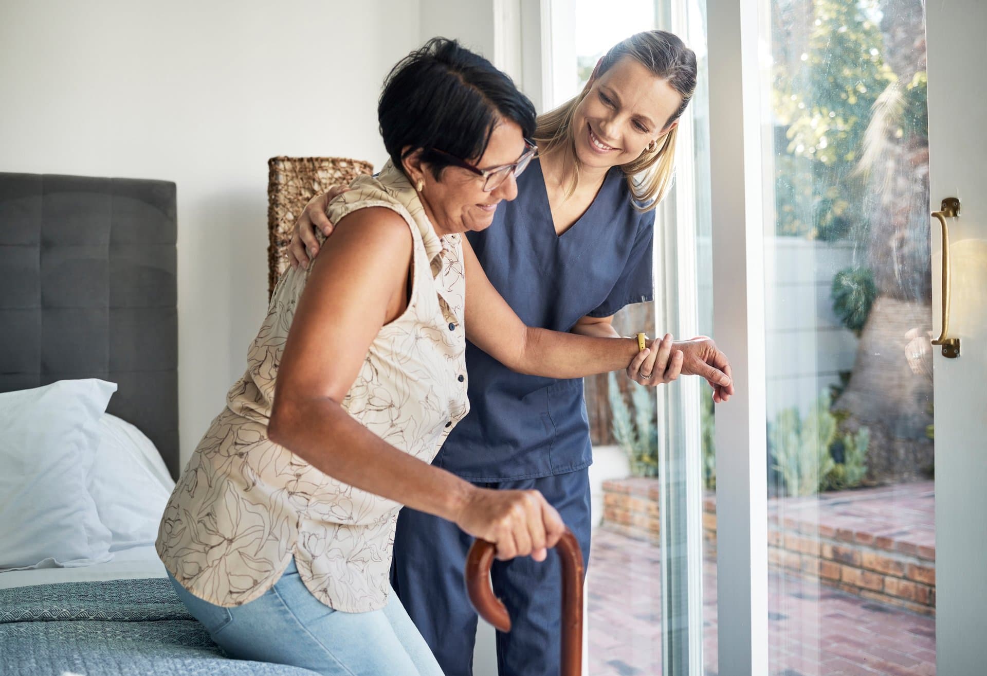 Caregiver helping senior woman maintain independence in her Greater Houston area home